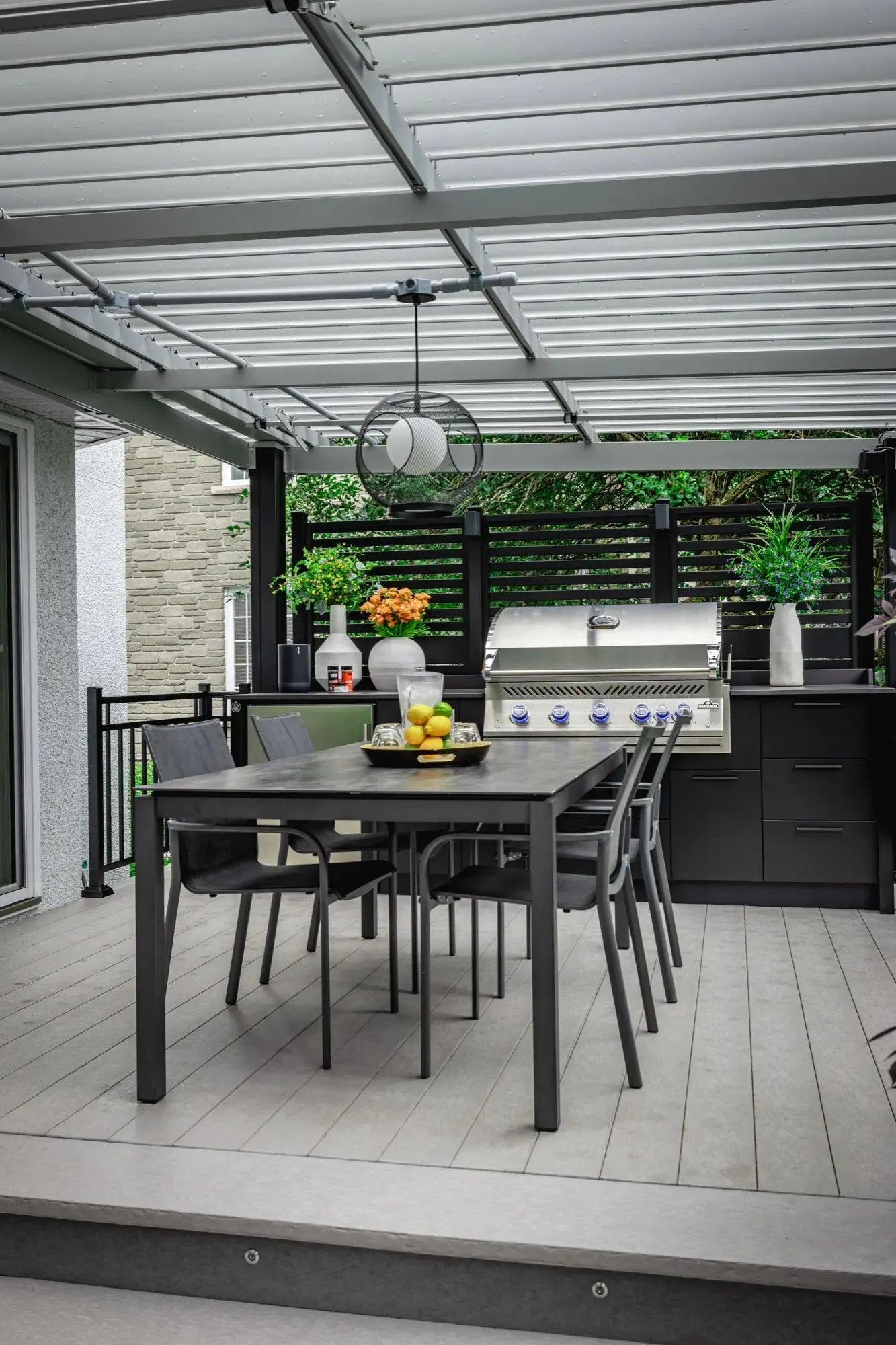 The covered terrace — the full outdoor kitchen seen from the yard